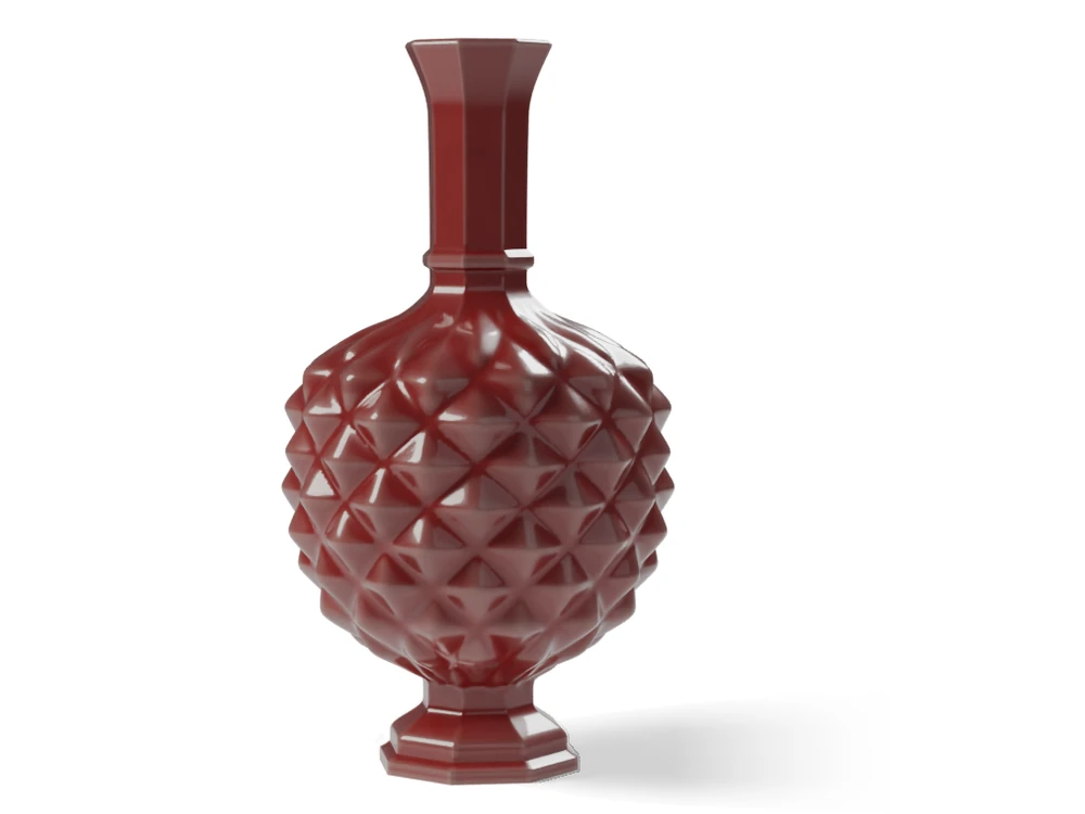 The Diamond Point urn in a deep red glaze: an eight-sided foot, a body covered in diamond points and a tall eight-sided neck