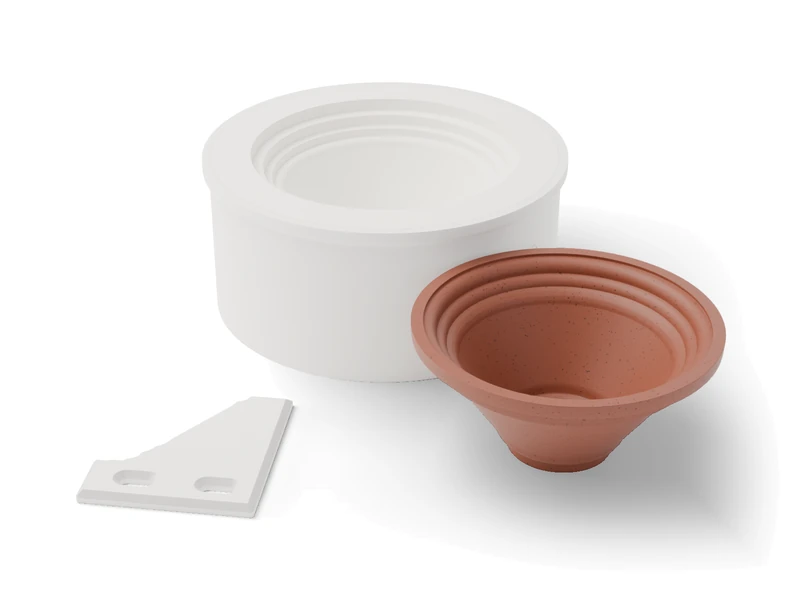 A plaster jigger mold in its white printed case, the stepped-rim clay bowl it formed and the printed profile template