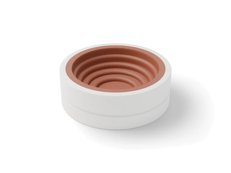 A white printed press mold lined with a pressed clay bowl of four stepped terraces